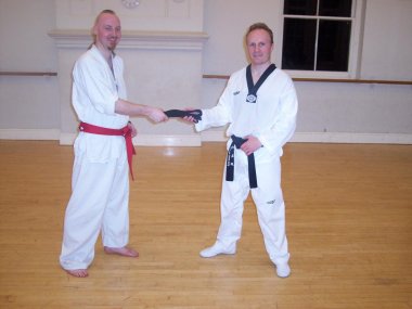 Master Evans presents Mr Tovey with his Black Belt